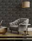 Living room with gray sofa, decorative table, and patterned wall featuring dog illustrations.