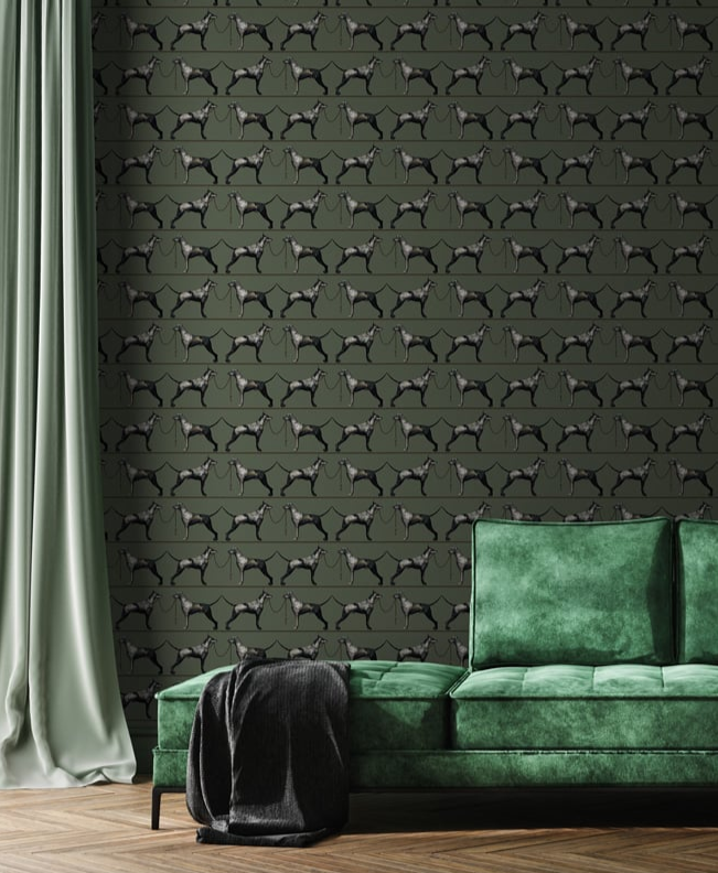 Green sofa against a wall with dog pattern wallpaper