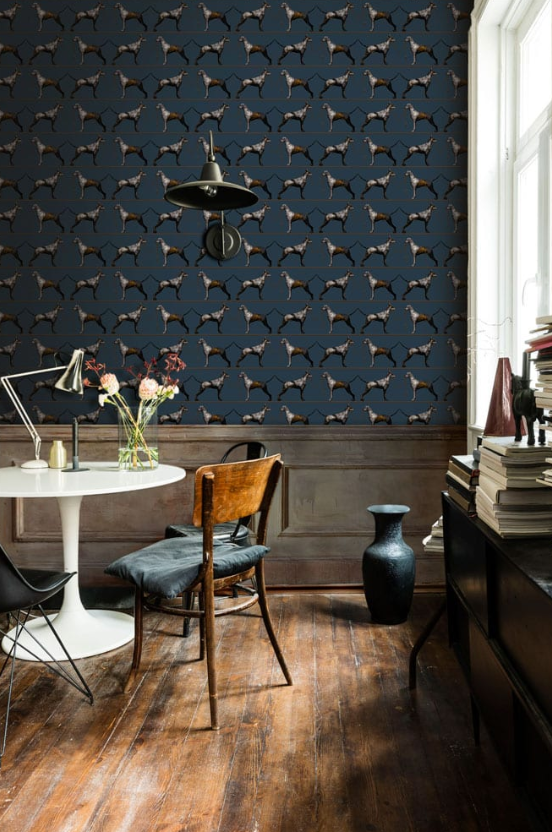 Room interior with blue wallpaper featuring dog pattern, wooden floor, and modern furniture.