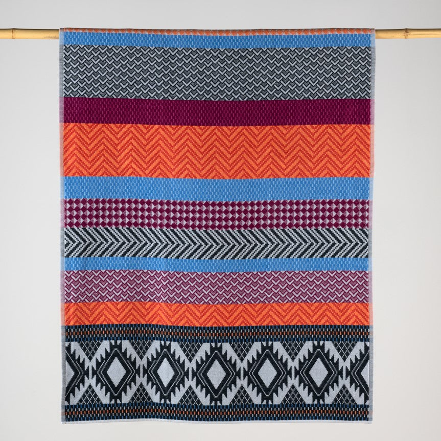 Aztec patterned towel in orange, black red and blue