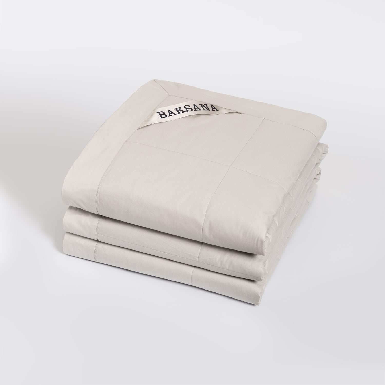 feather filled bedspread with 'BAKSANA' branding on a white background