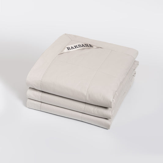 feather filled bedspread with 'BAKSANA' branding on a white background