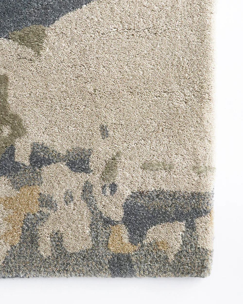 Close-up of a textured rug with a camouflage pattern in neutral colors.
