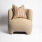 Beige armchair with a striped pillow on a white background