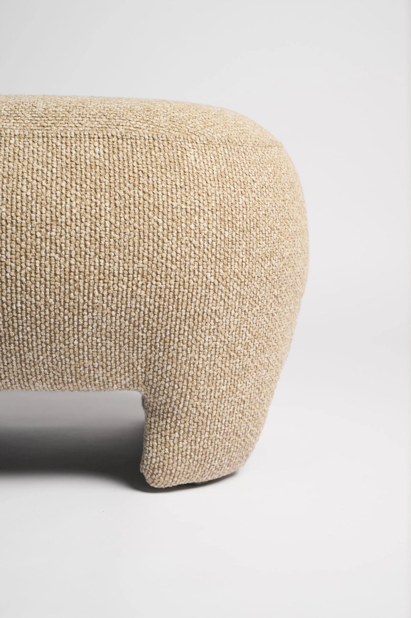 Beige textured ottoman on a white background