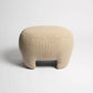 Beige textured ottoman on a white background