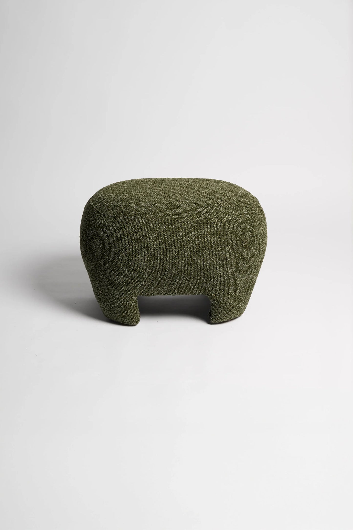 Green textured ottoman on a white background