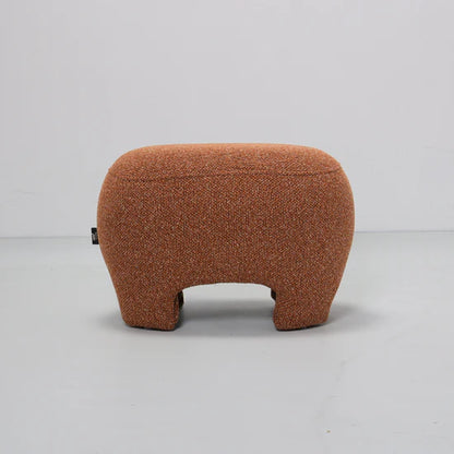Brown textured ottoman on a light gray background