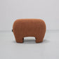 Brown textured ottoman on a light gray background