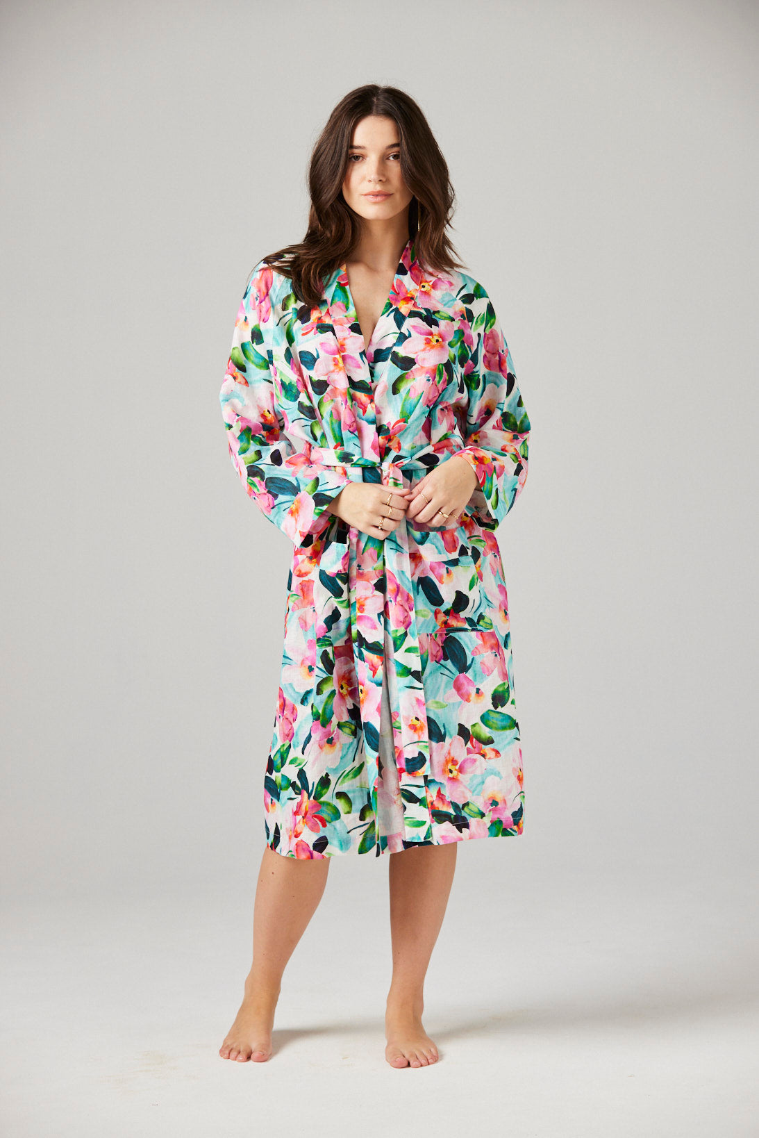 Woman wearing a floral robe against a plain background