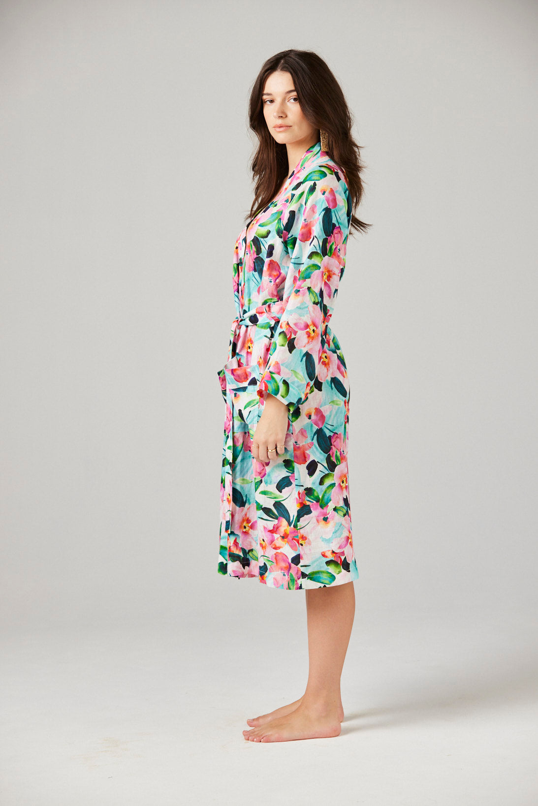 Woman wearing a floral robe on a plain background