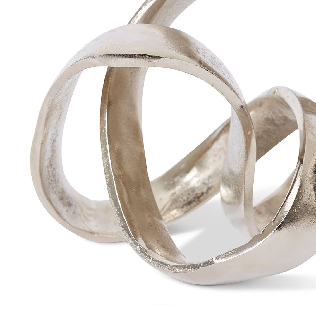 Silver interlocking rings on a white background