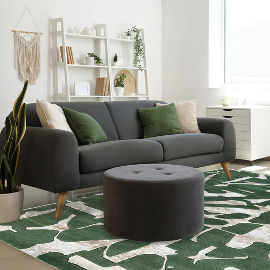 Gray sofa with green and beige cushions in a living room setting.