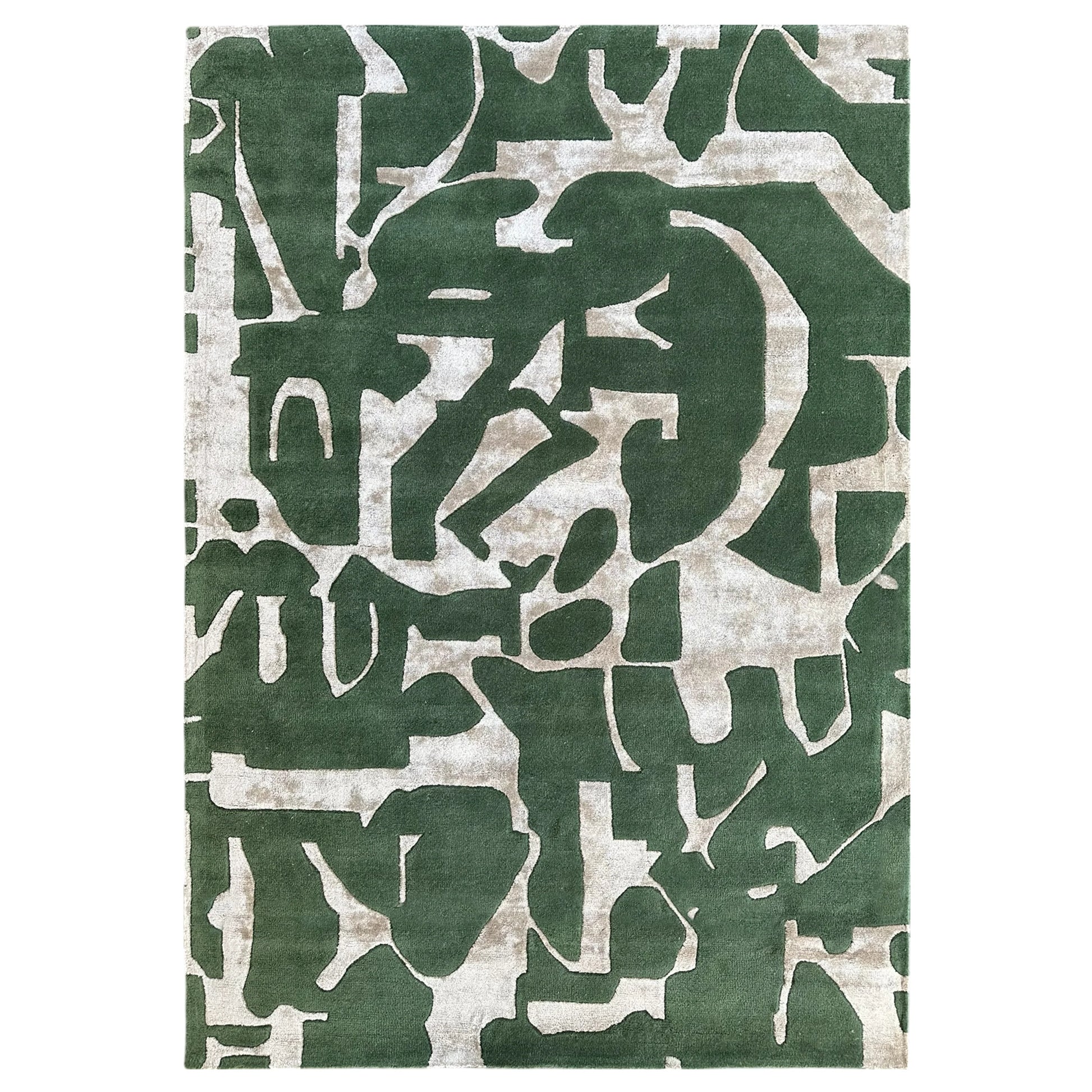 Green and beige abstract patterned rug on a white background