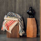 stripey wool throws over a wooden ottoman