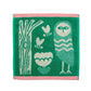 Green towel with owl and nature-themed design on a white background