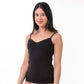 Woman wearing a black camisole on a white background