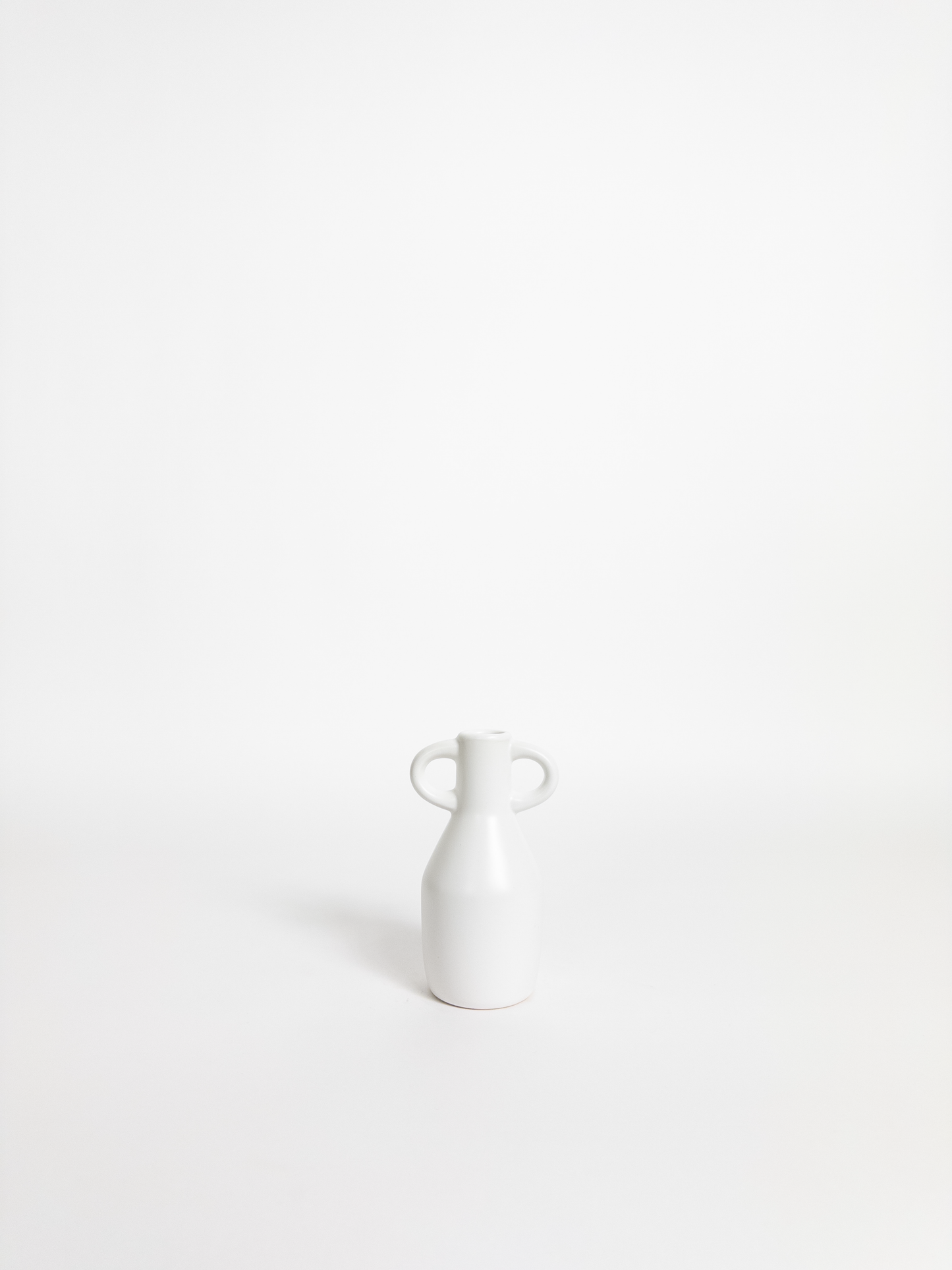 White ceramic vase on a white background