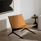 Modern living room with a brown chair, gray sofa, and black coffee table.