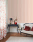 Living room with striped wallpaper, floral curtains, and decorative furniture.