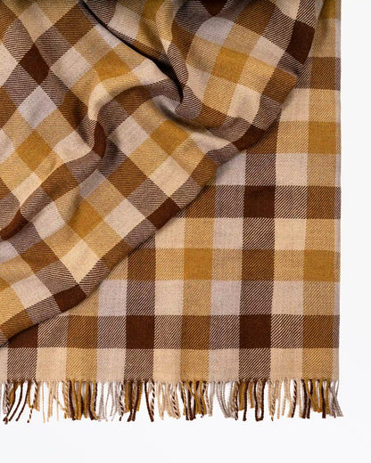 Plaid blanket with brown, beige, and white pattern on a white background