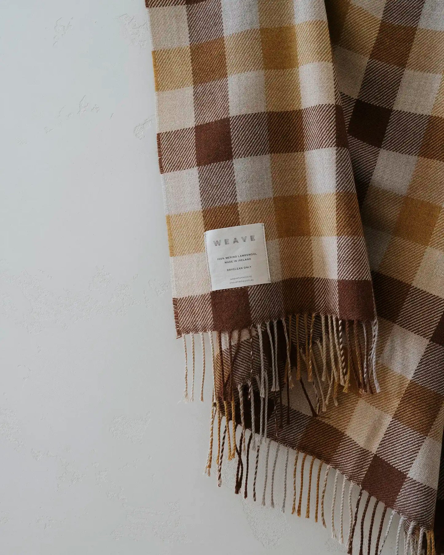 Plaid scarf with fringes on a white background