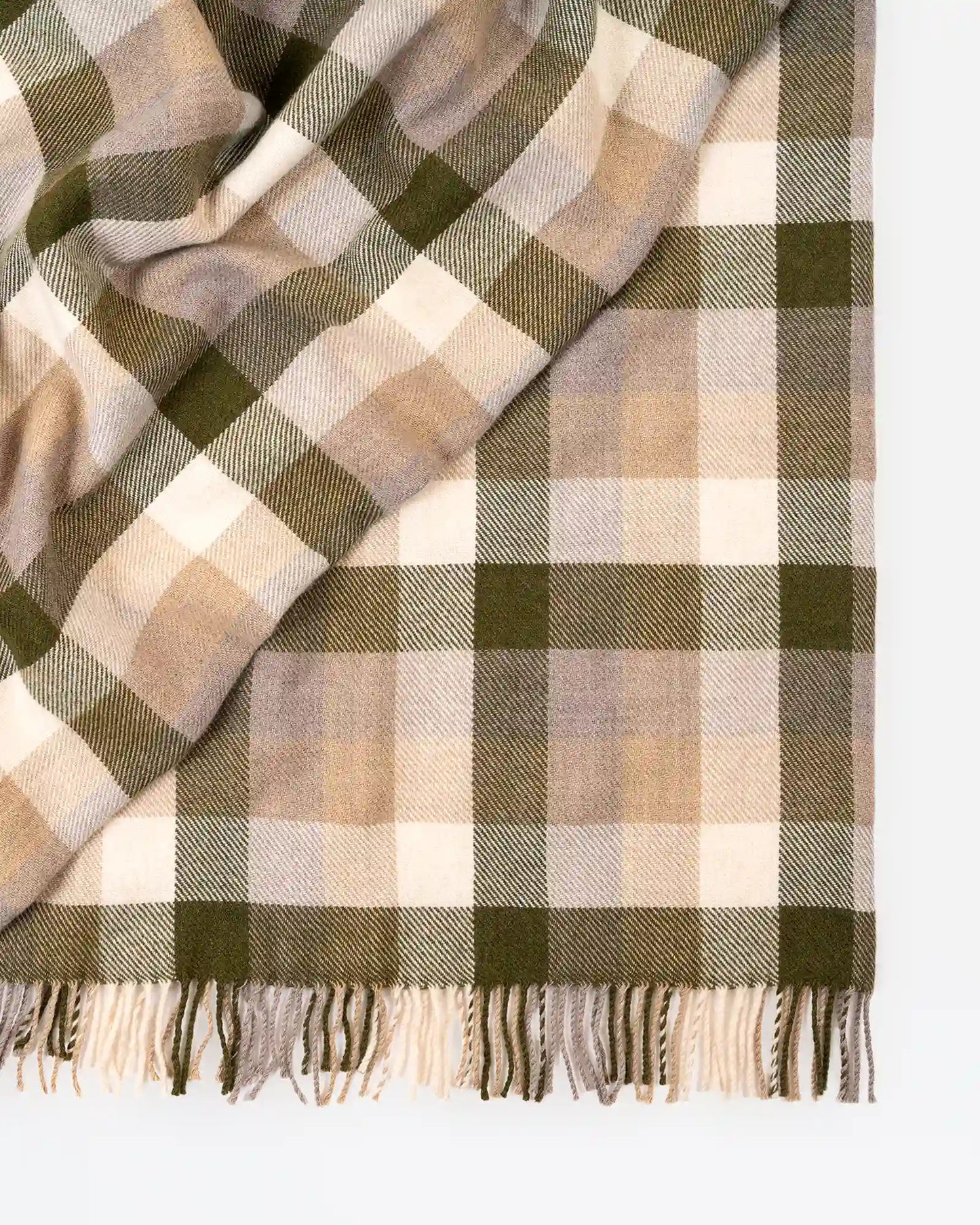 Plaid blanket with green and beige colors on a white background