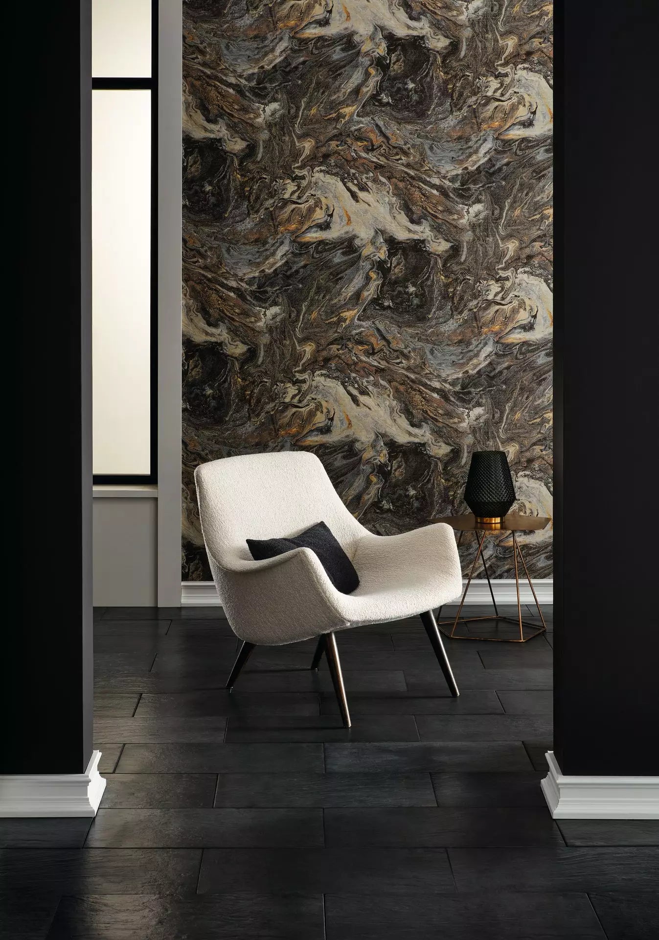 Modern interior with a white armchair against a textured wall.