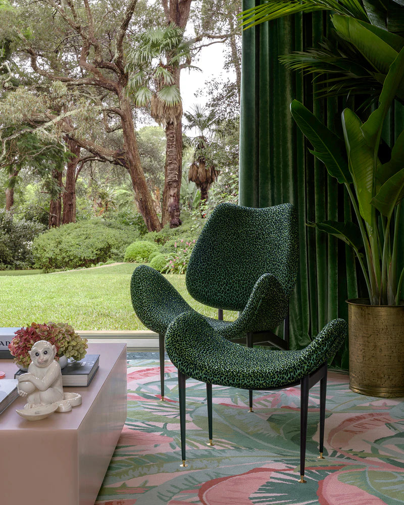 Modern green chairs in a stylish room with plants and decor