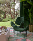 Modern green chairs in a stylish room with plants and decor