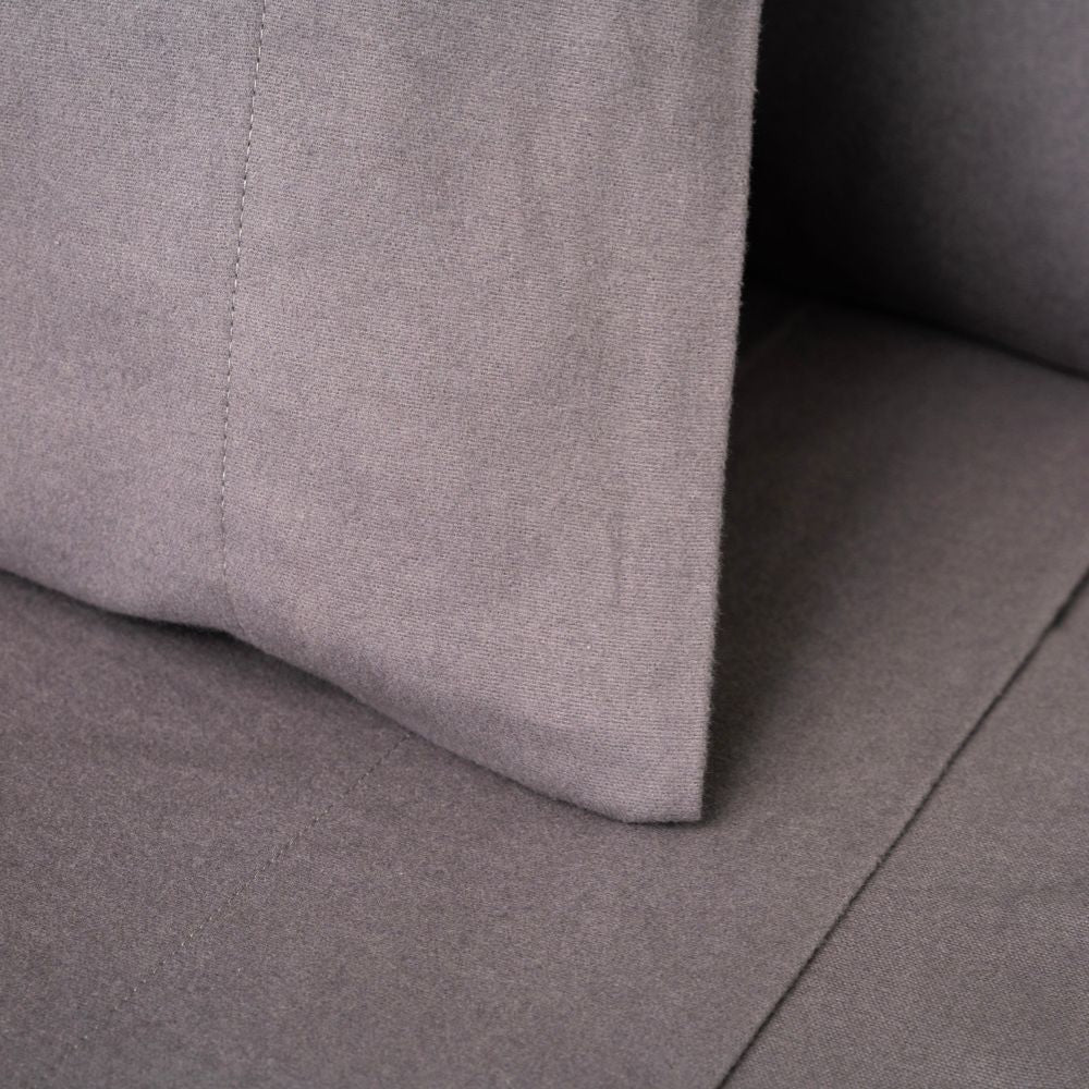 Close-up of a gray flannel pillowcase surface with a subtle texture