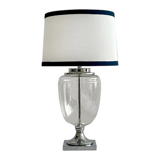 The Charlotte is a glass and nickel table lamp with white and navy shade
