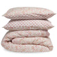 Floral patterned bedding set with a comforter and two pillows on a white background