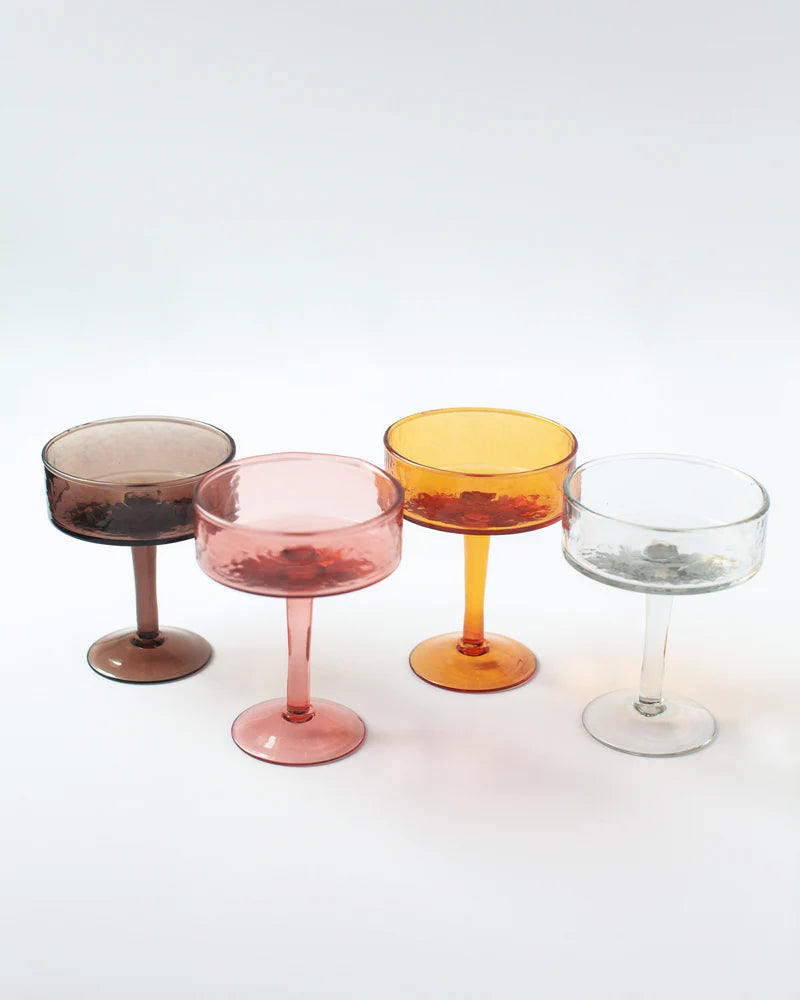 Four colorful glass goblets on a white background