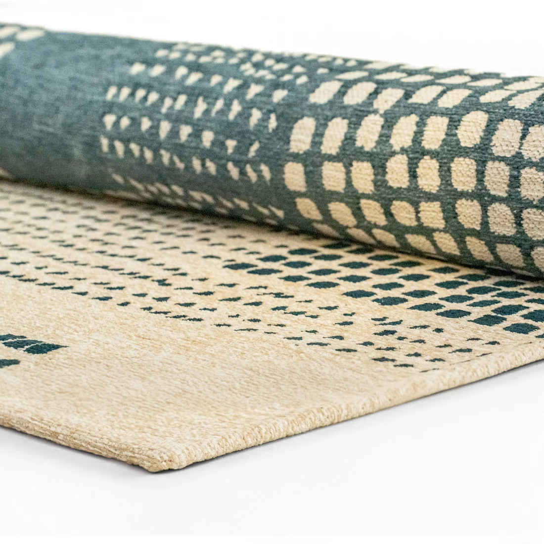 rolled up patterned rugs on a white background