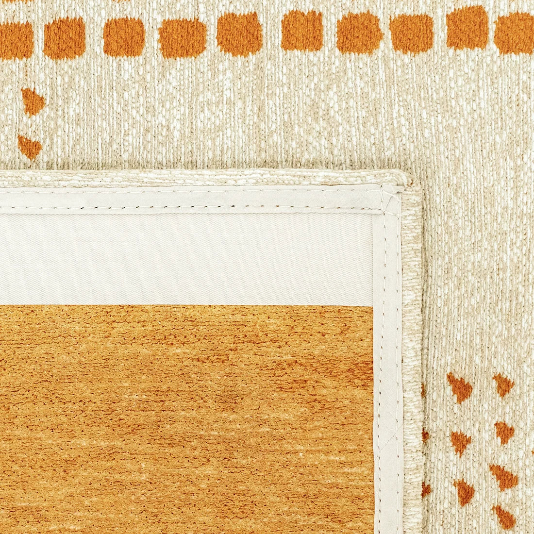 Close-up of a textured surface with orange and beige patterns