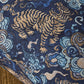 Decorative fabric with tiger and cloud pattern on a blue background