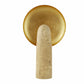 Decorative wall hook with gold circular plate and beige stone base on a white background