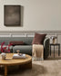 Modern living room with a gray sofa, wooden coffee table, and decorative items.