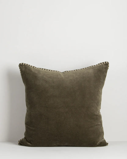 Olive pillow with decorative edge on a white background