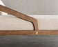 Close-up of a wooden bed frame with beige mattress on a neutral background