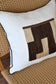 Decorative pillow with geometric pattern on a woven chair