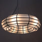 Stained glass pendant light with a geometric pattern on a dark background