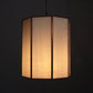 Hexagonal lamp with a warm glow on a black background