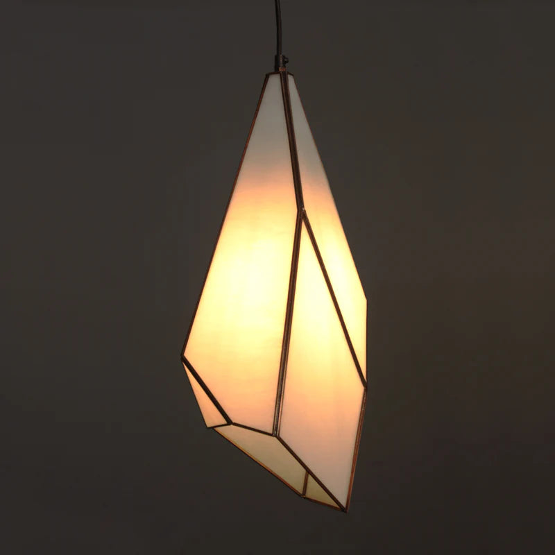 Geometric pendant light with a warm glow on a dark background