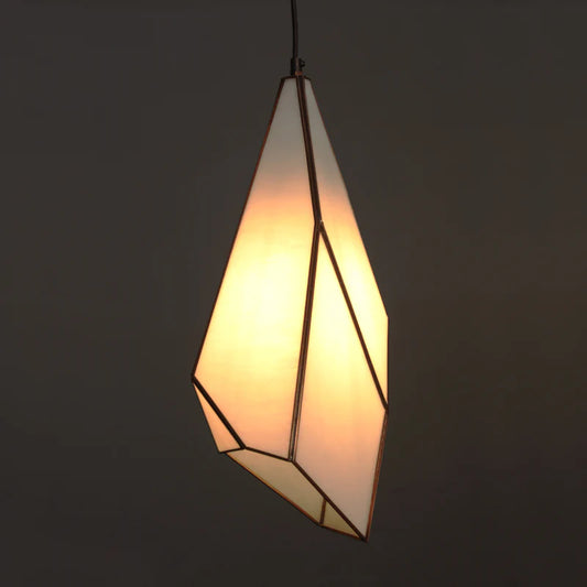 Geometric pendant light with a warm glow on a dark background