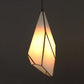 Geometric pendant light with a warm glow on a dark background