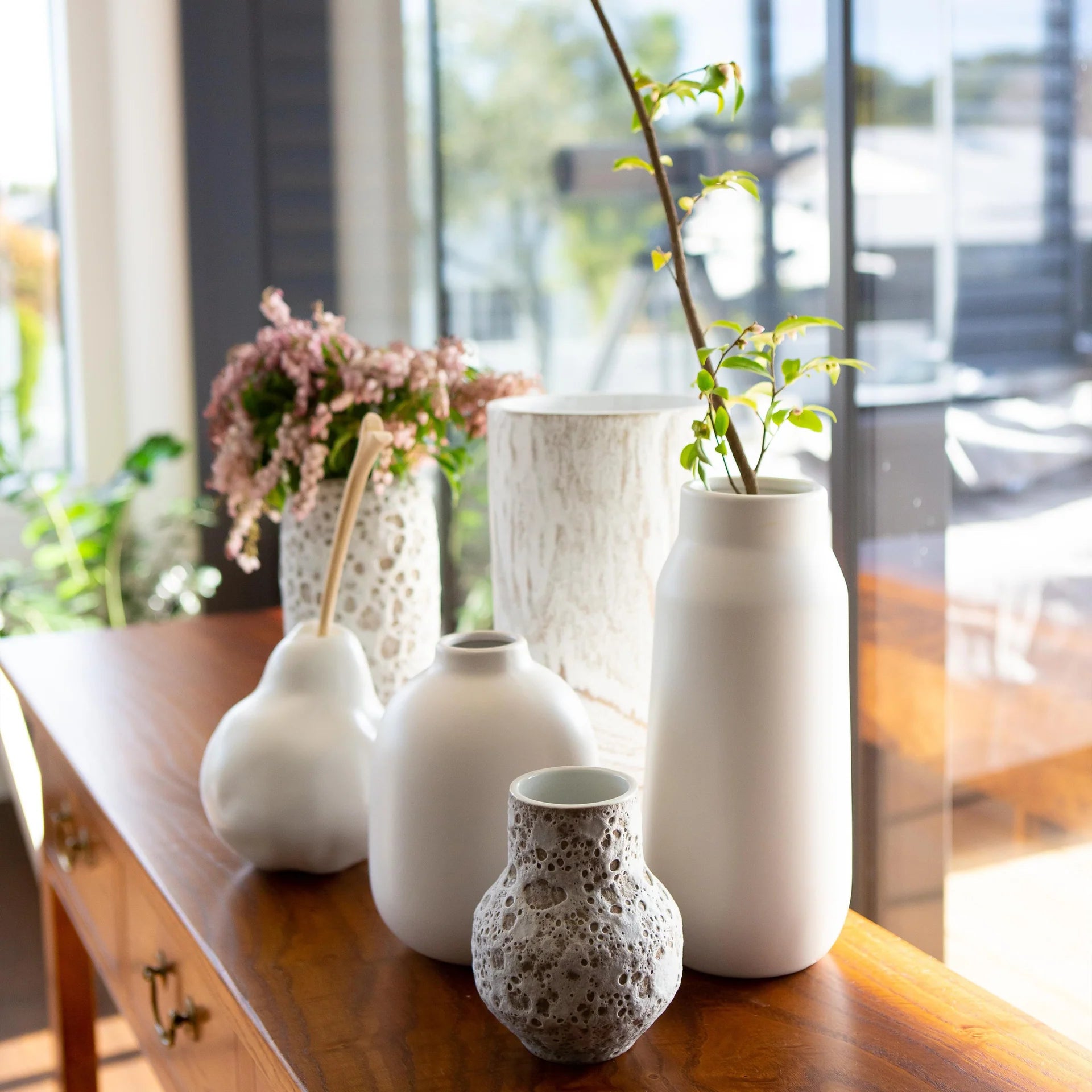 table with white vases and decorative objects