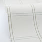 Close-up of a white fabric with black stitching on a white background