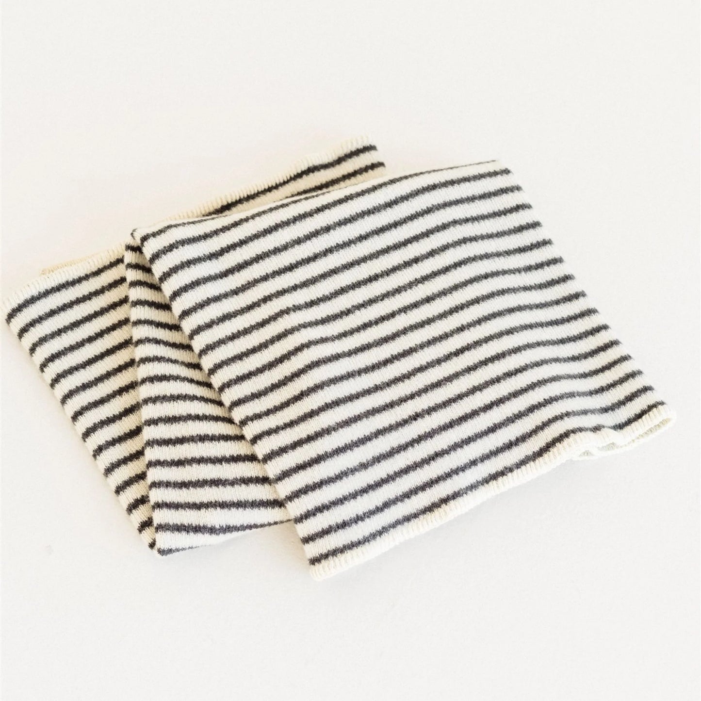 Striped fabric with black and white lines on a light background